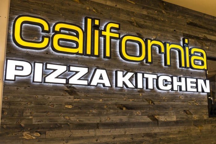 California Pizza Kitchen Logo illuminated sign on wall